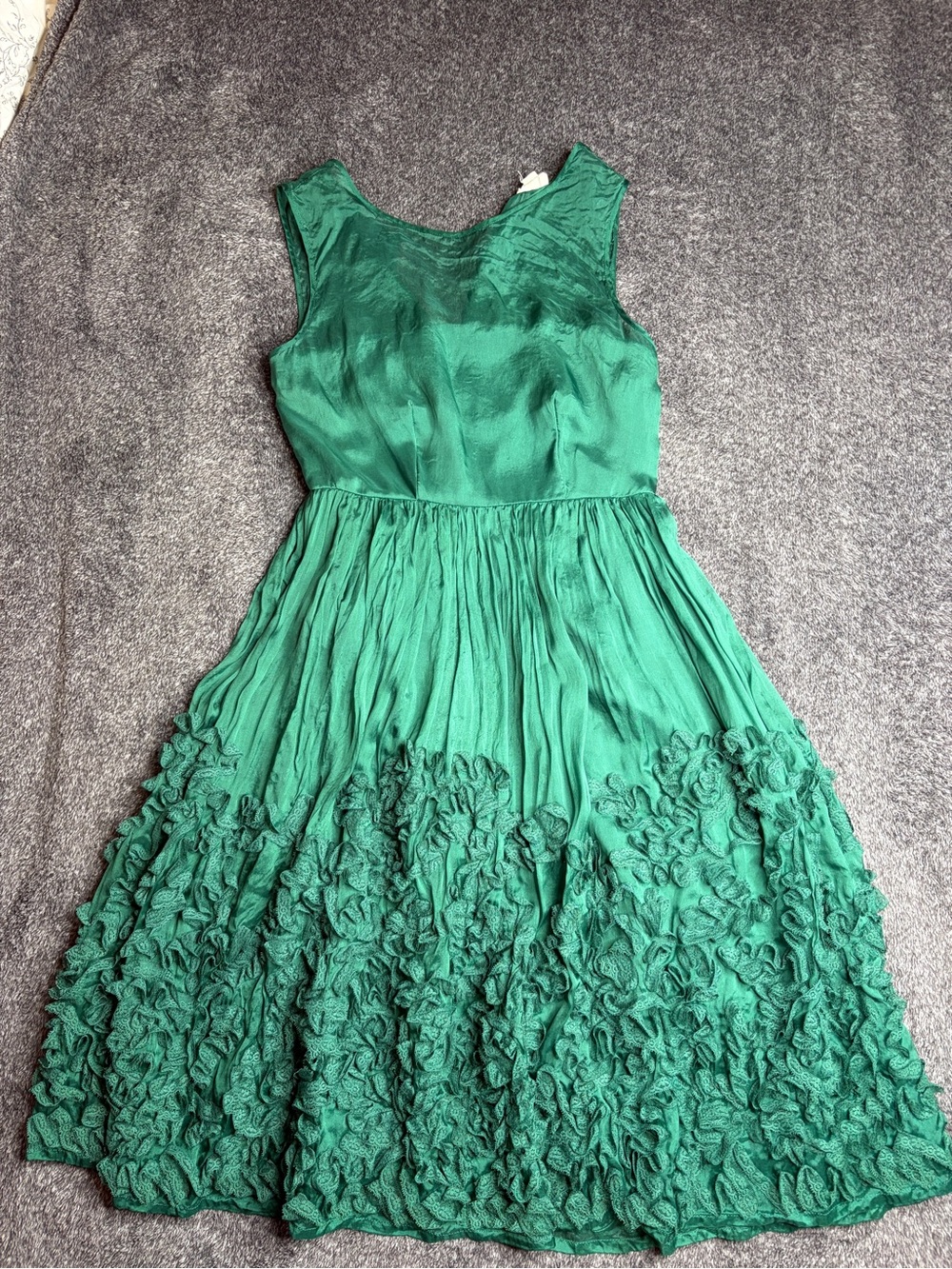 This is an Anthropologie Tiny Caridad Ruffle Silk Dress in green.